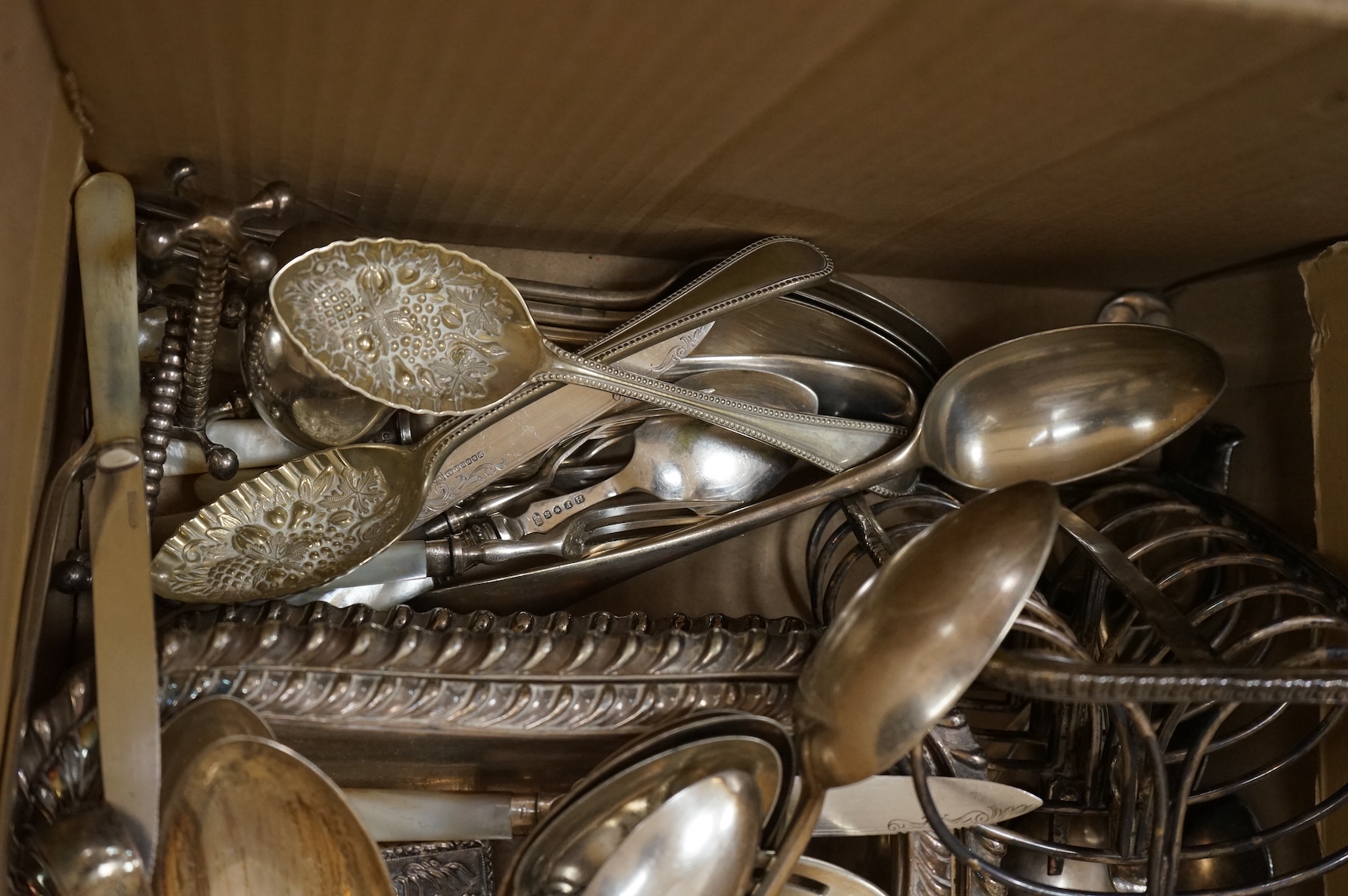A group of assorted plated items including entree dishes, flatware and wine coaster.